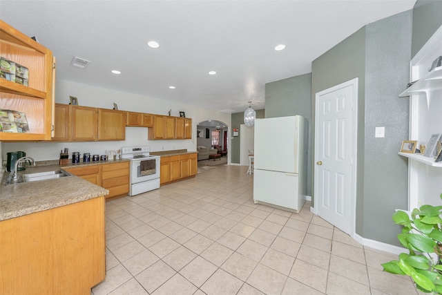 kitchen featuring light tile patterned flooring, sink, and white appliances