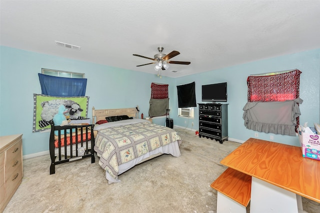 bedroom with light carpet, cooling unit, ceiling fan, and a textured ceiling