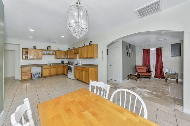 kitchen with sink, hanging light fixtures, an inviting chandelier, light tile patterned floors, and white range with electric cooktop