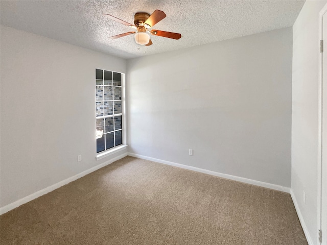 empty room with a textured ceiling, carpet floors, and ceiling fan