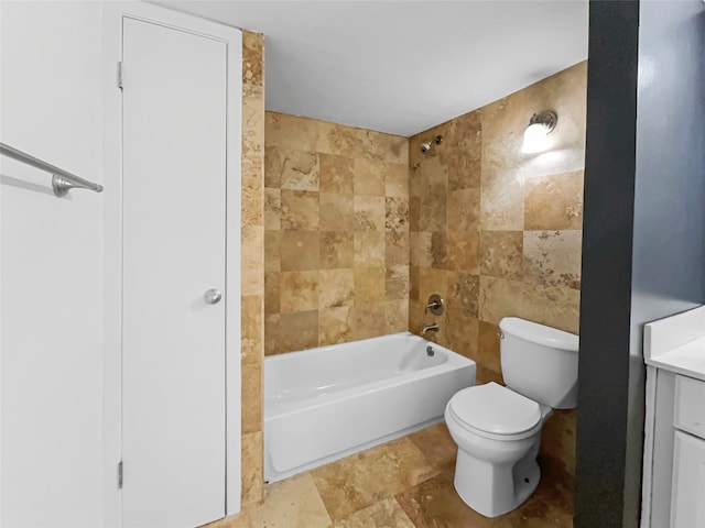 full bathroom with tile flooring, tile walls, tiled shower / bath combo, vanity, and toilet