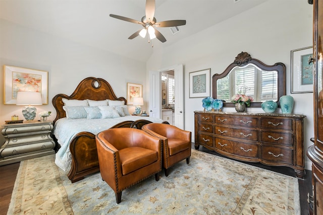 bedroom with vaulted ceiling, ensuite bath, ceiling fan, and light wood-type flooring