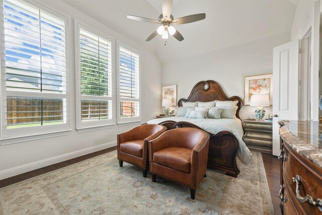 bedroom with ensuite bathroom, ceiling fan, light hardwood / wood-style floors, and lofted ceiling