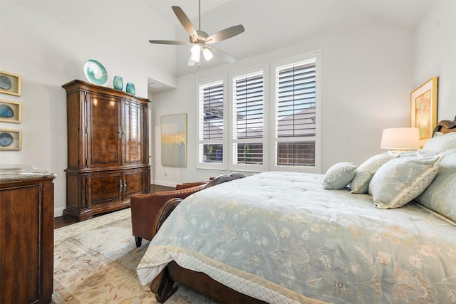 bedroom featuring ceiling fan, lofted ceiling, and hardwood / wood-style floors