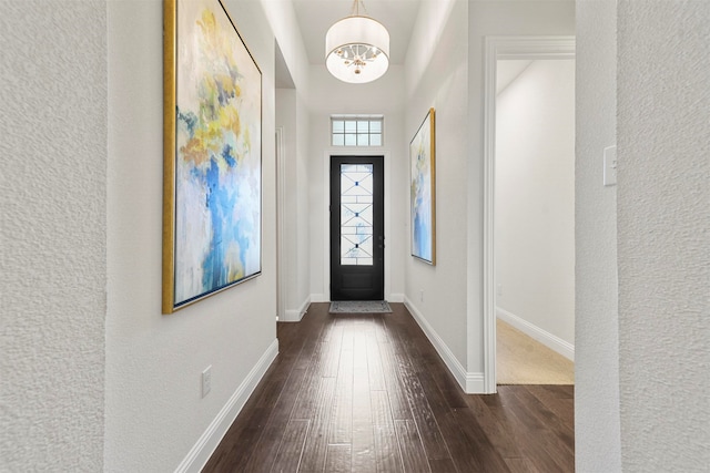 entryway with a chandelier and dark hardwood / wood-style floors