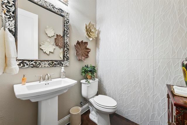 bathroom featuring hardwood / wood-style floors, toilet, and sink