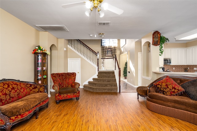 living room with light hardwood / wood-style floors and ceiling fan