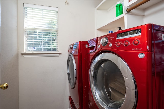 clothes washing area featuring washing machine and clothes dryer and a wealth of natural light