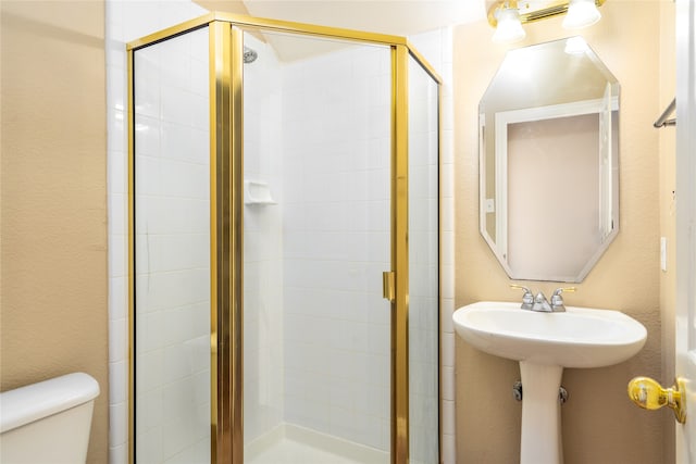 bathroom with an enclosed shower and toilet