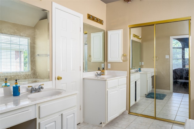 bathroom featuring tile floors and double sink vanity