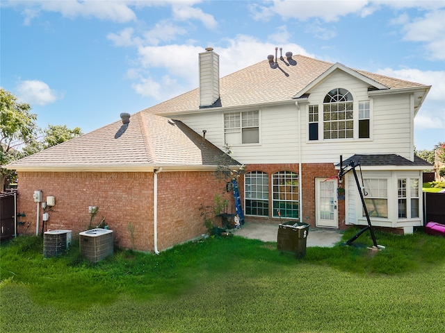 back of property featuring a yard and central air condition unit