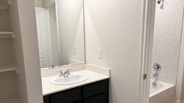 bathroom featuring vanity and  shower combination