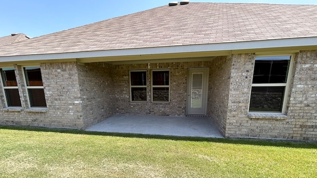 back of property featuring a patio and a lawn