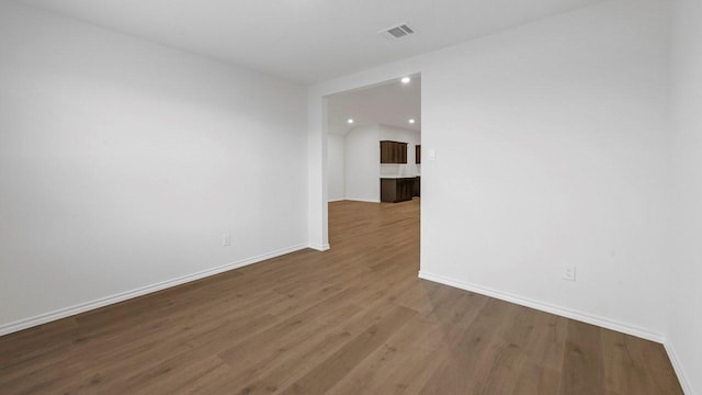 spare room featuring wood-type flooring