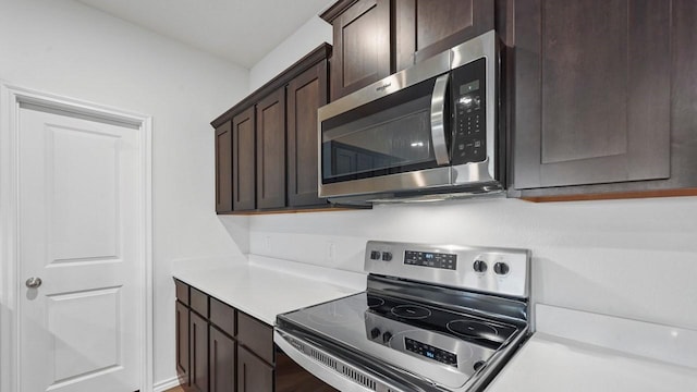 kitchen featuring appliances with stainless steel finishes and dark brown cabinets