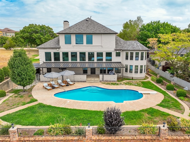 exterior space featuring a yard, a fenced in pool, and a patio