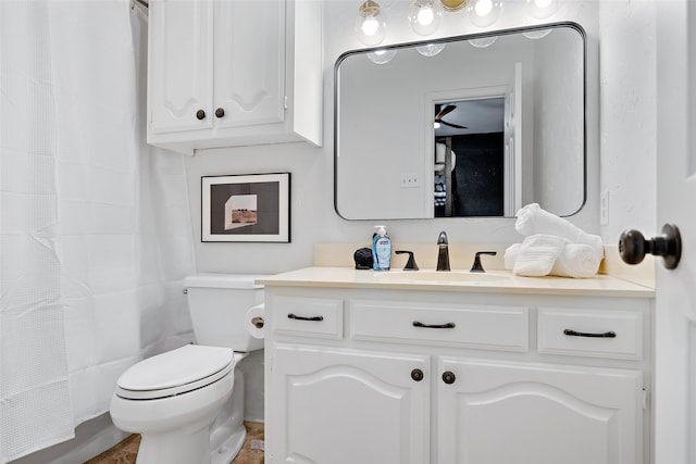 bathroom with tile floors, vanity with extensive cabinet space, and toilet