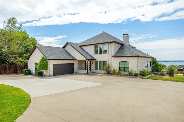 french provincial home featuring a garage