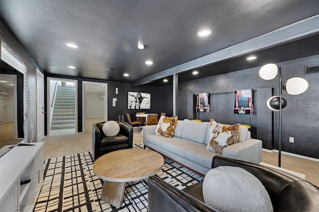 carpeted living room with a textured ceiling