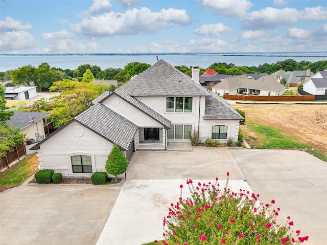 view of front facade featuring a water view and a patio area