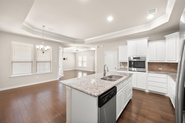 kitchen featuring sink, white cabinetry, stainless steel appliances, a center island with sink, and a raised ceiling