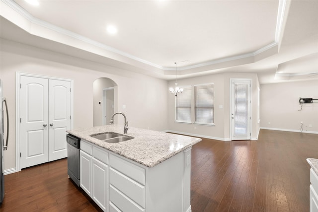 kitchen featuring an island with sink, white cabinetry, sink, a tray ceiling, and stainless steel appliances