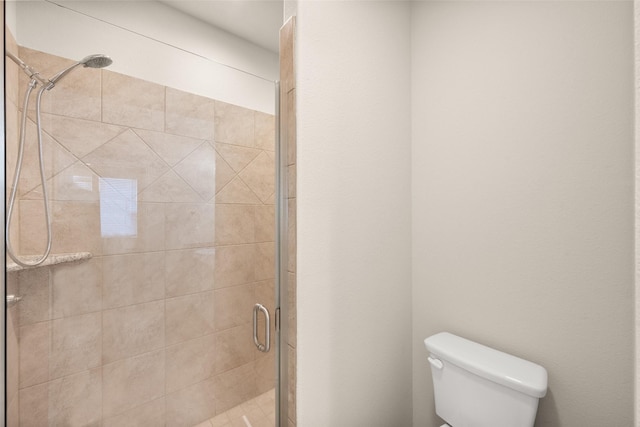 bathroom featuring an enclosed shower and toilet