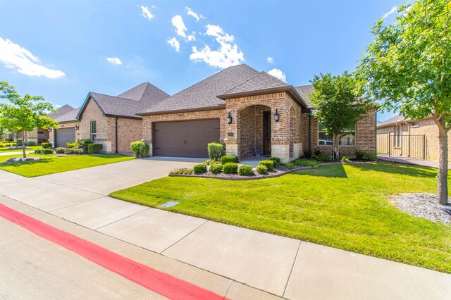 view of front of house featuring a front lawn and a garage