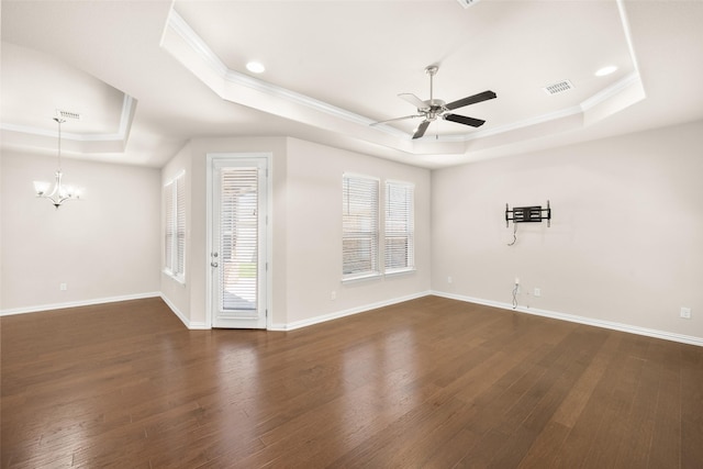 unfurnished living room featuring crown molding, dark hardwood / wood-style floors, a raised ceiling, and ceiling fan with notable chandelier