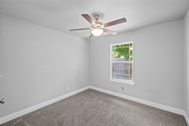 carpeted empty room featuring ceiling fan