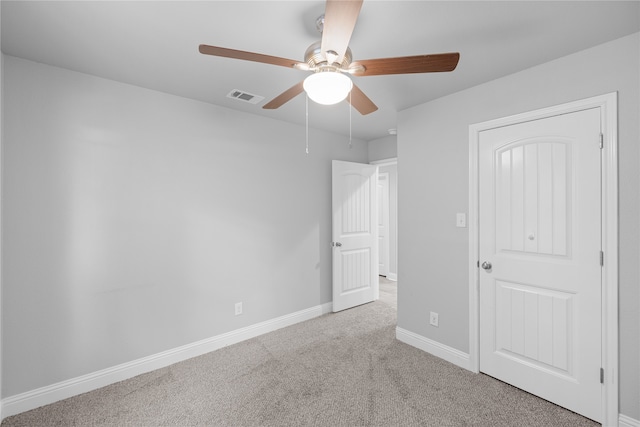 unfurnished bedroom with ceiling fan and light carpet