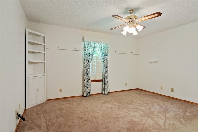 unfurnished bedroom with ceiling fan, baseboards, carpet floors, and a textured ceiling