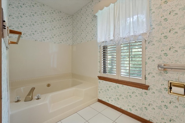 bathroom featuring tile patterned floors, baseboards, wallpapered walls, and a garden tub