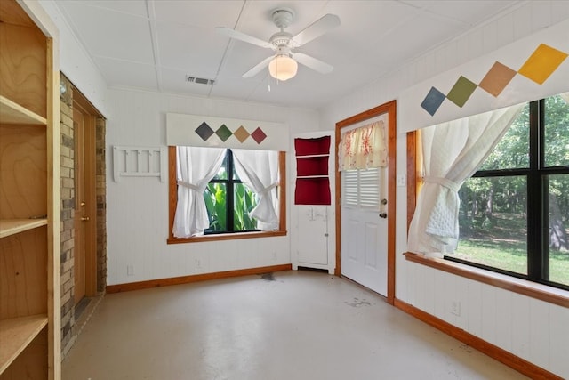 spare room with visible vents, a ceiling fan, baseboards, and finished concrete floors