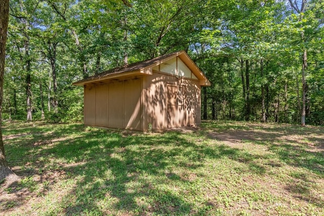 view of shed featuring a view of trees