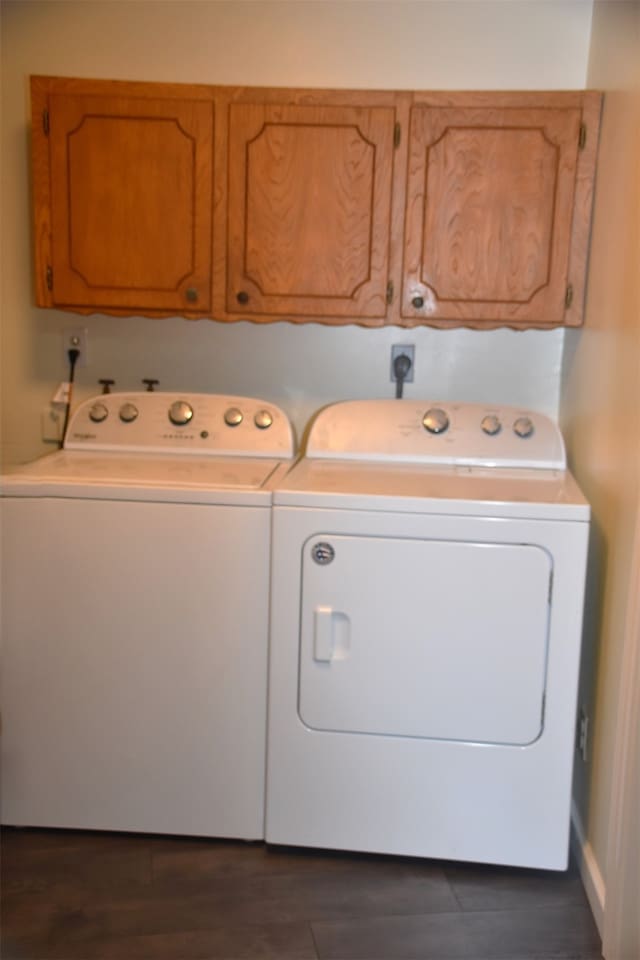 clothes washing area with cabinets, dark wood-type flooring, hookup for an electric dryer, and washer and clothes dryer