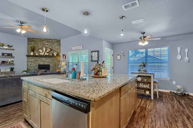 kitchen featuring sink, dark wood-type flooring, black range with gas stovetop, stainless steel dishwasher, and an island with sink