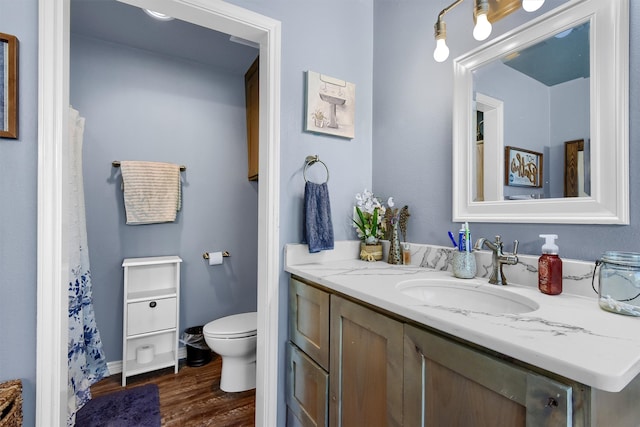 bathroom with a bathing tub, vanity, and wood-type flooring