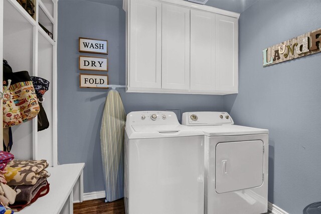 washroom featuring independent washer and dryer, rail lighting, and hardwood / wood-style floors