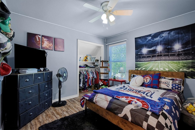 bedroom featuring hardwood / wood-style flooring, ceiling fan, and a closet