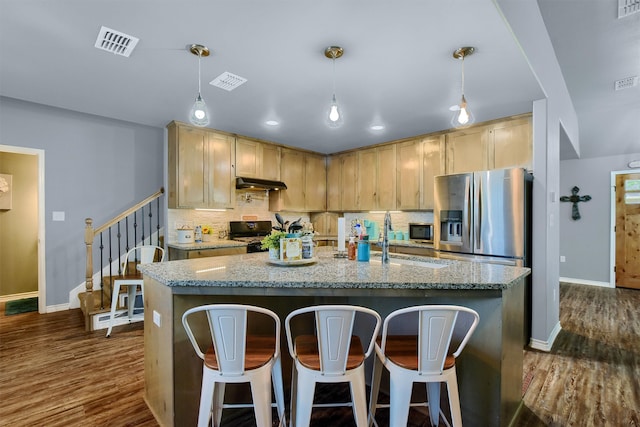 kitchen featuring ventilation hood, decorative light fixtures, dark hardwood / wood-style floors, and stainless steel appliances