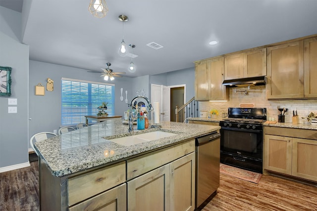 kitchen featuring sink, black range with gas stovetop, stainless steel dishwasher, dark hardwood / wood-style floors, and a kitchen island with sink