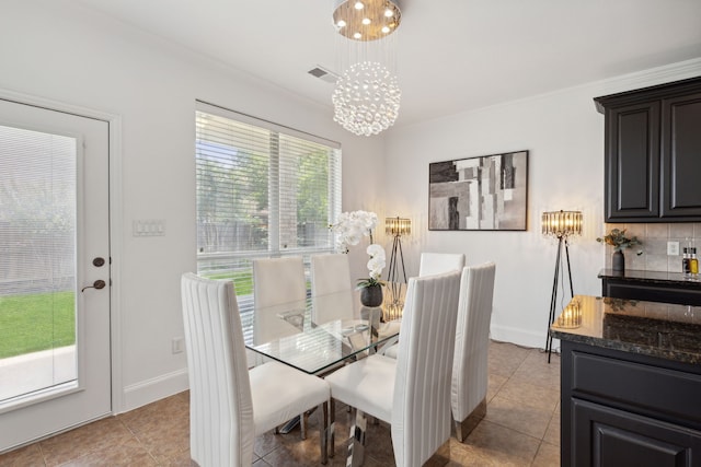 dining area featuring a notable chandelier, a wealth of natural light, and light tile patterned floors