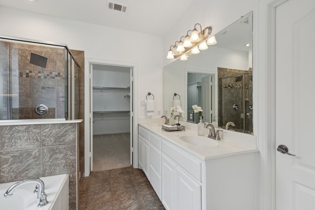 bathroom featuring tile patterned floors, plus walk in shower, and vanity