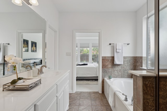 bathroom featuring vanity, a bathtub, and tile patterned floors