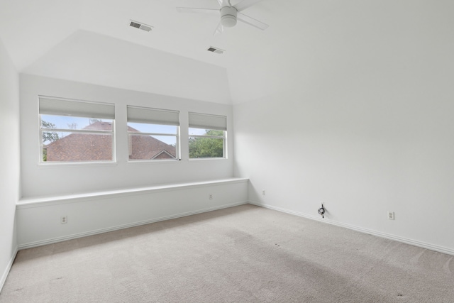 spare room with lofted ceiling, carpet floors, and ceiling fan