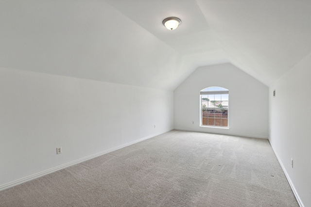 bonus room featuring lofted ceiling and carpet