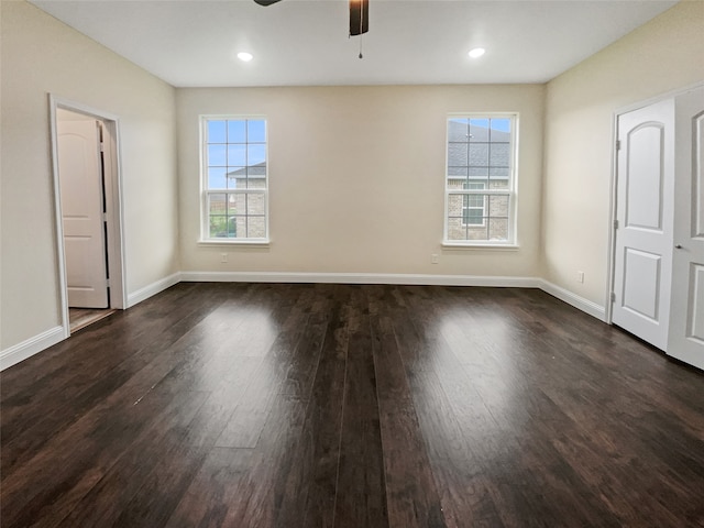 unfurnished room with dark hardwood / wood-style floors and ceiling fan