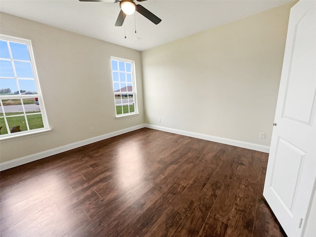 empty room featuring dark wood-type flooring and ceiling fan