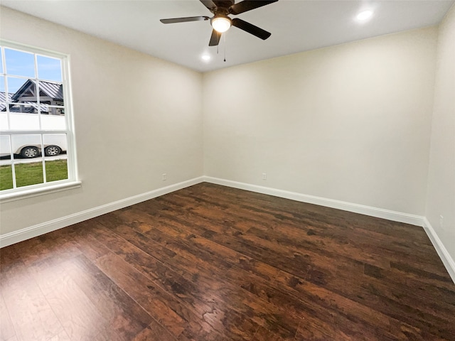 spare room featuring a wealth of natural light, ceiling fan, and hardwood / wood-style flooring